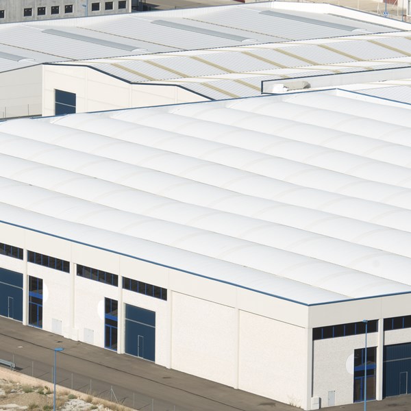 Industrial commercial building with ultrawhite cool roofing created with use of LUMINEX C ultrawhite durable filler.