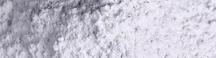 Close up pile of bright white nepheline syenite mineral.