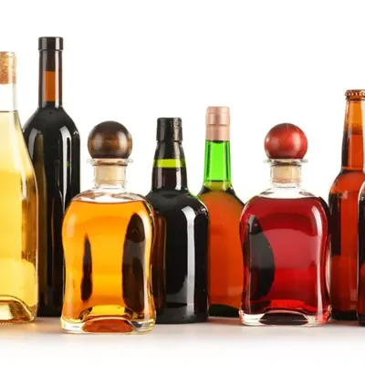 Assortment of glass bottles and glasswares in various colors and sizes created with PURESIL extra low iron glass sand for consistent batches