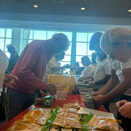 people in front of a table with food on it