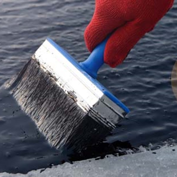 Worker applying exterior coating that utilizes IMSIL microcrystalline silica filler to resist weathering and improve durability in abrasive or corrosive environments.