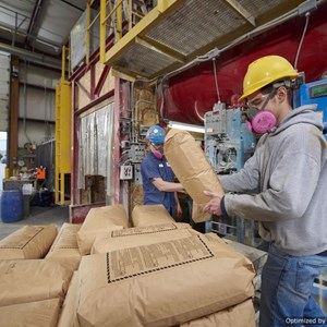 Black Lab Toll Blending worker loading a pallet of customer bags for stocking program and direct ship option for customer growth and success.