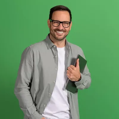 man on green background smiling