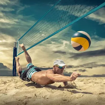 Professional athlete volleyball player hitting ball in court of high performance, clean, off-white, angular BESTSAND VB volleyball sand for high quality competition.