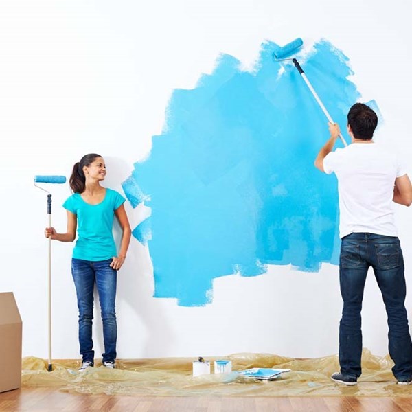 Couple painting interior walls with painting using Minex functional fillers for excellent sheen, durability, and color retention