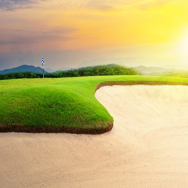 Dramatic landscape of bright greens and clean white BESTSAND Signature bunker sand.