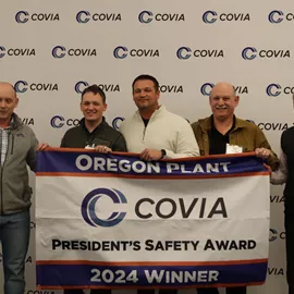 Covia team holding an award banner