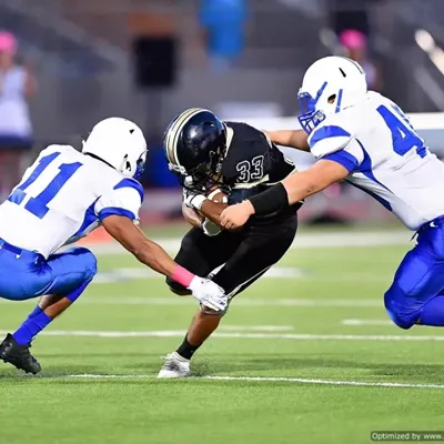 Professional athletes playing football on sports turf field that utilizes high performance BESTSAND athletic sand made with safety and performance as top priority.