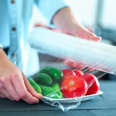 Food handler applying food grade plastic film wrap created with MINBLOC HC series high clarity antiblock additive for films, made from nepheline syenite to create the best haze, gloss and clarity values.